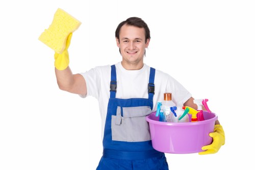 Domestic cleaner carrying out routine home cleaning in a Lambeth flat
